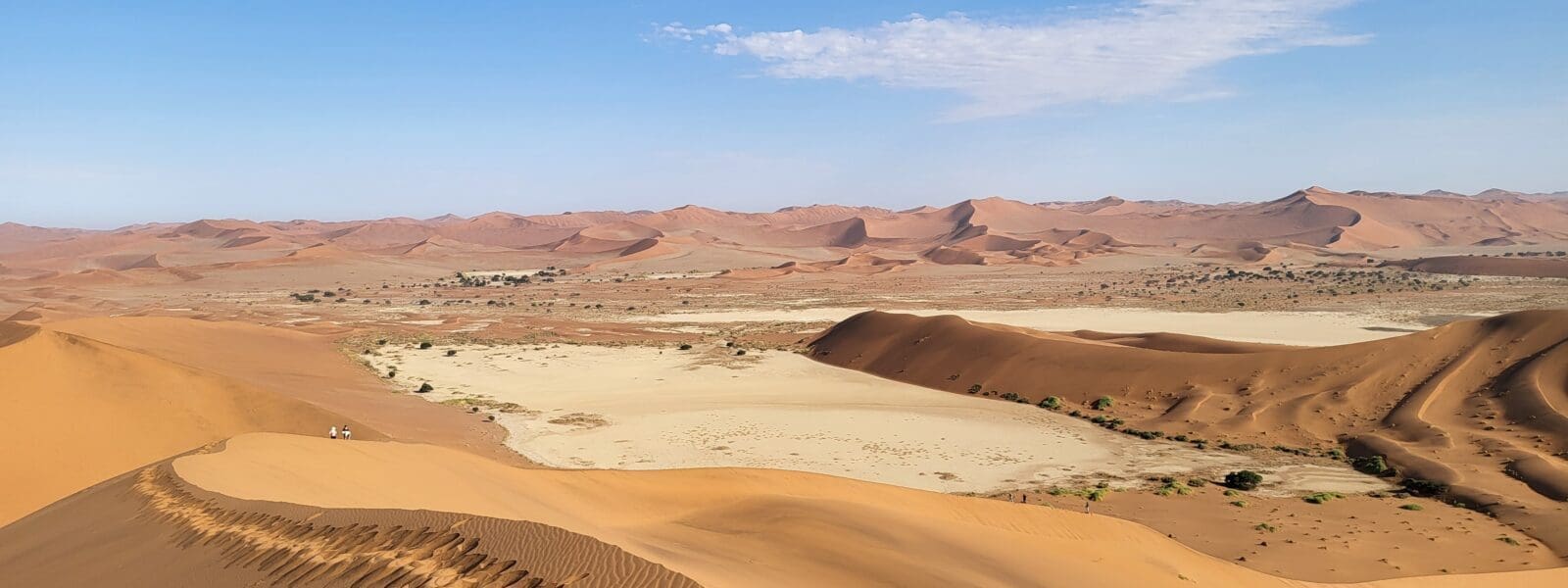 a sand dunes with a blue sky