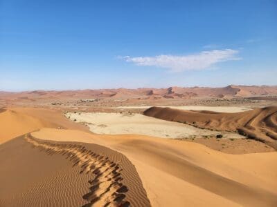 a sand dunes with a blue sky