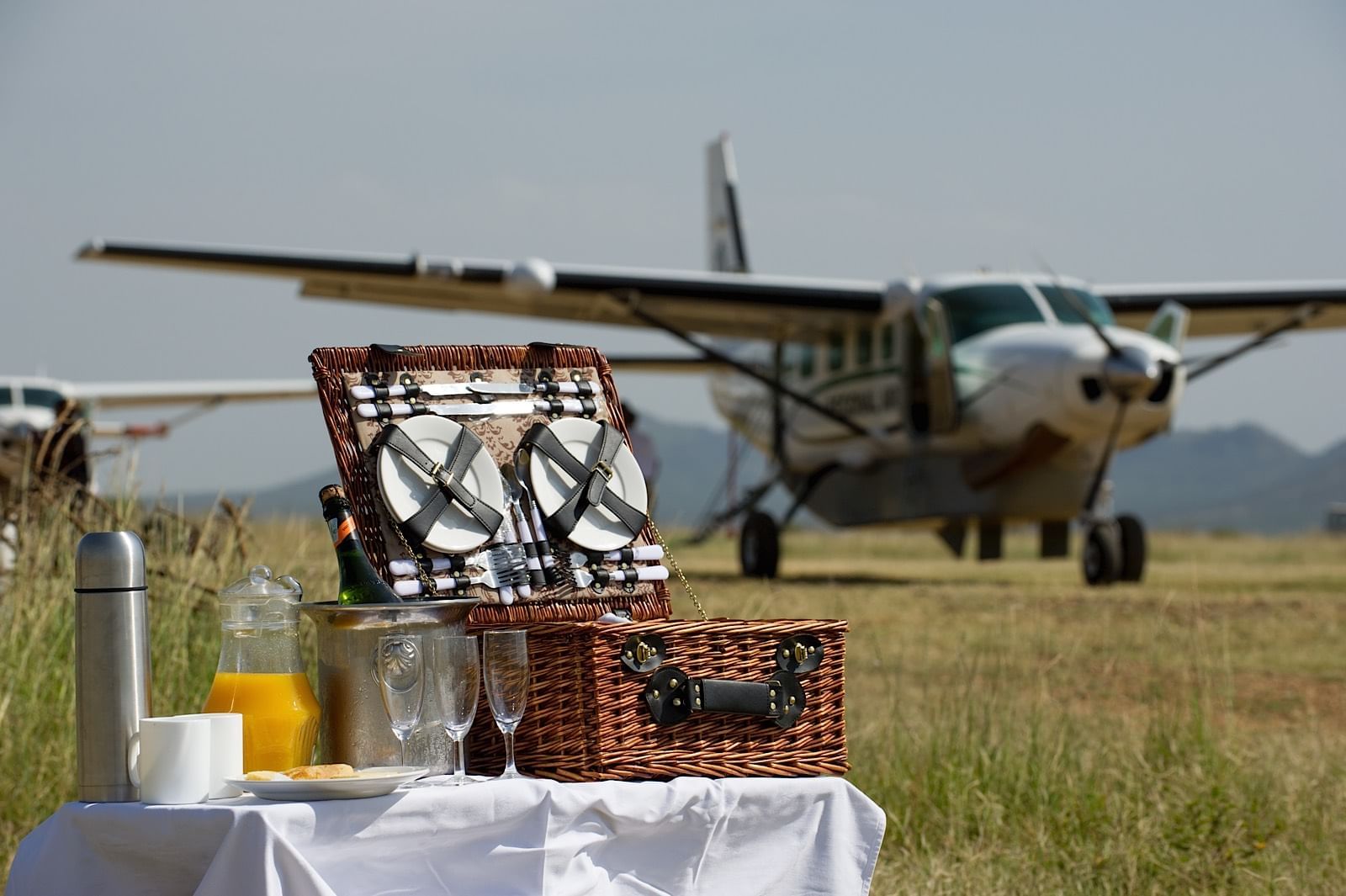 Dinner Table With Plane in Background | Sandy Tracks